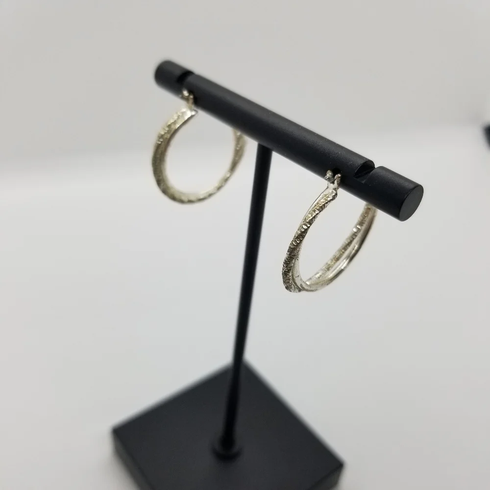silver tone textured twist hoop earrings